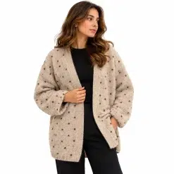 Woman wearing a beige open-front wool cardigan with brown polka dots