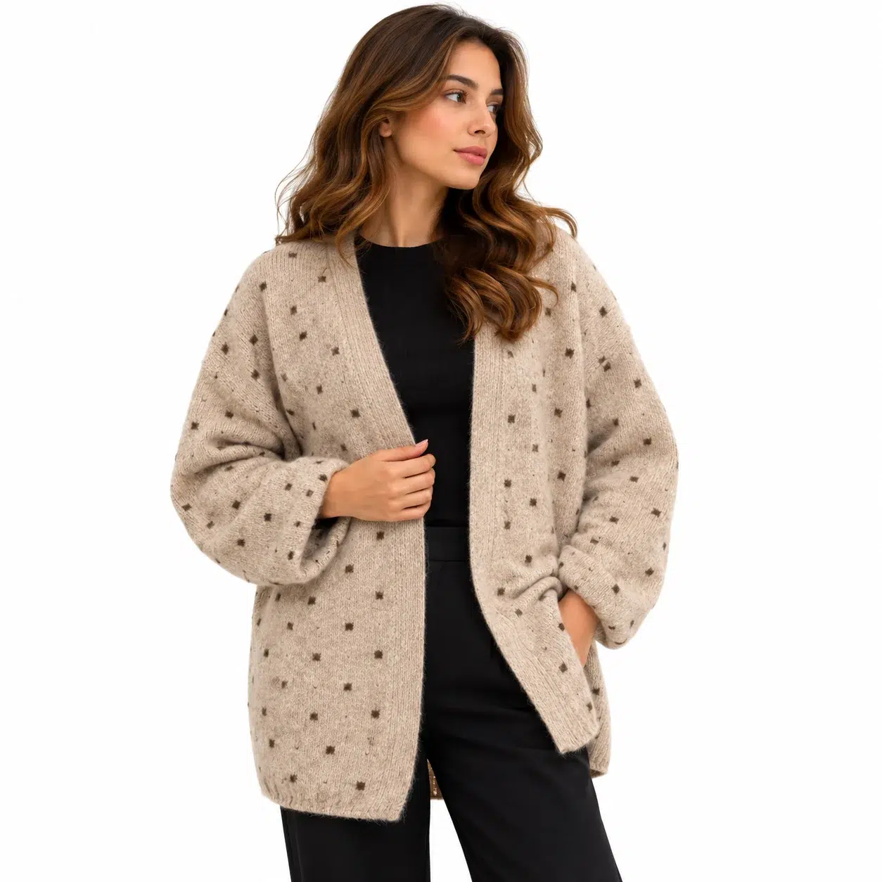 Woman wearing a beige open-front wool cardigan with brown polka dots